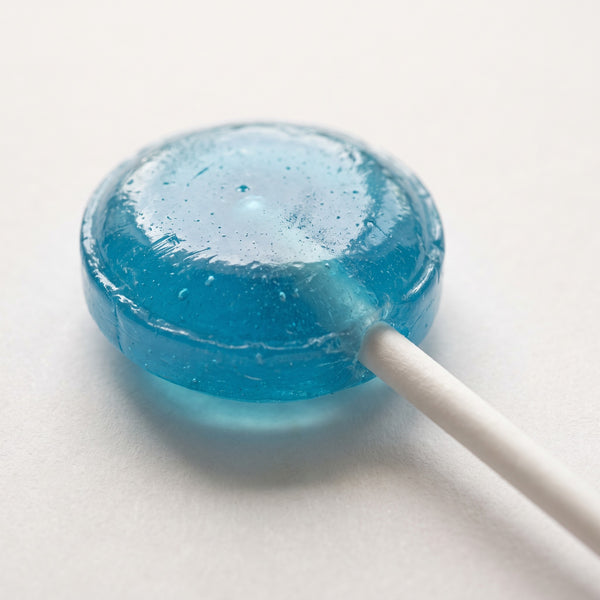 Blue cotton candy flavored lollipop on a white stick